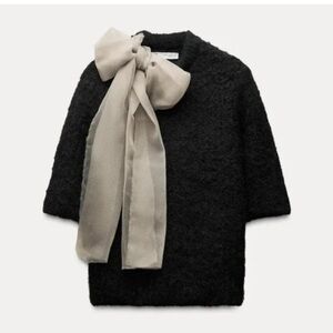 Elegant Black Sweater with Cream Bow